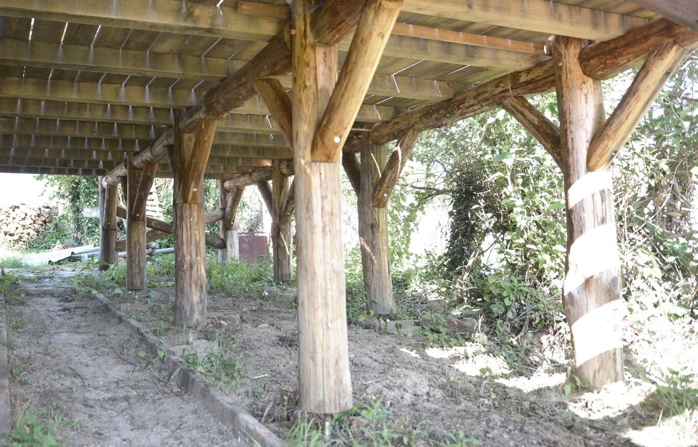 Finished wood-framed structure, assembled and standing on site